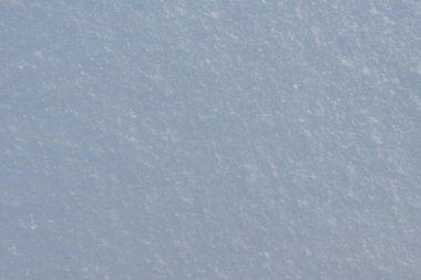 Kar taneleri olan yumuşak bir kar yığınının yüzeyi