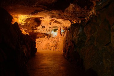The corridors and walls of the cave are red