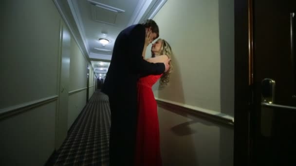 Sevgi dolu çift kucaklayan ve otel koridorda öpüşme — Stok video