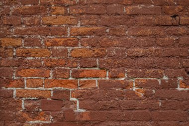 Eski, pejmürde, kırmızı bir duvarın soyut arkaplanı.