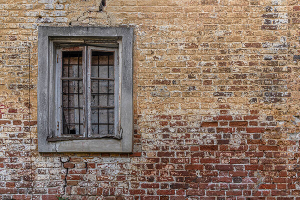 Abstract background of red brick wall and broken window of an old abandoned building