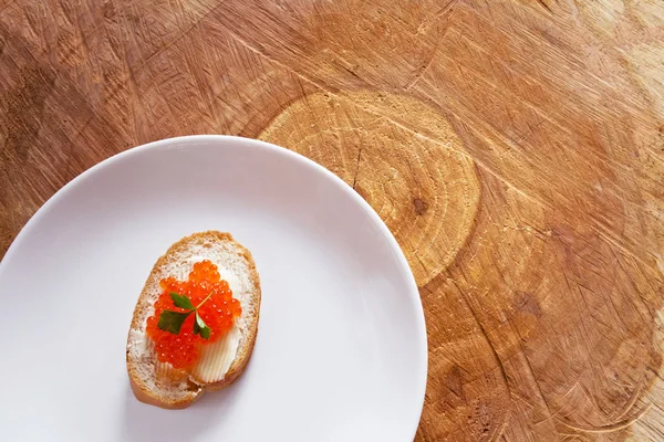 Sandwich con caviar rojo salmón en plato blanco — Foto de Stock
