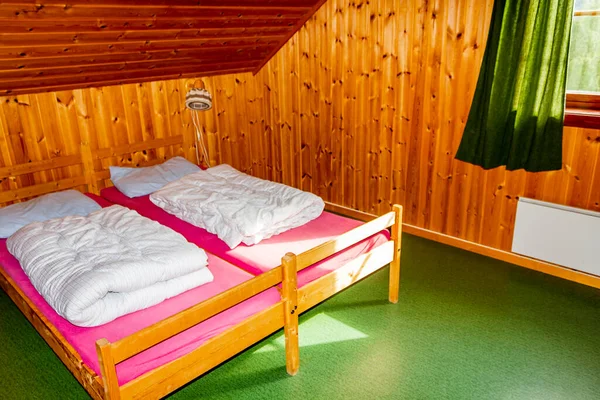 Cottage vacation interior decoration. Bedroom with beds in Vang i Valdres, Norway.