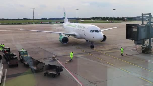 机场窗口 日耳曼尼亚航空公司的飞机停靠在乘客登机桥上 — 图库视频影像