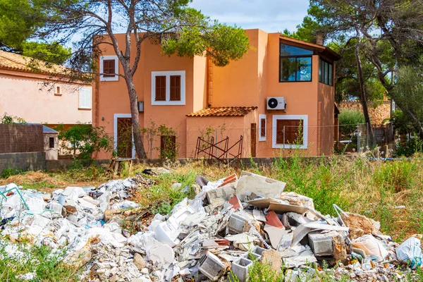 Typical spanish house with garden and rubble construction site on Mallorca Spain.