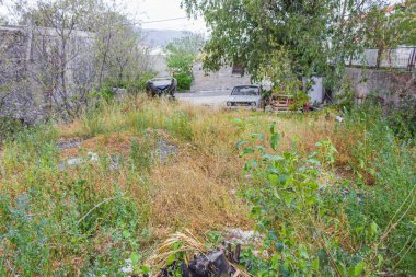 Eski bozuk küçük araba Novi Vinodolski Hırvatistan 'daki kaotik bahçeye park edilmiş..