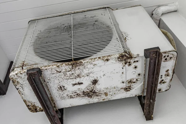 Dirty old rusted air conditioner at hotel room in Nai Thon Naithon Beach Phuket Thailand.