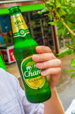 Dünya turisti FARANG Nai Thon Naithon Plajında Tayland birası Chang Thalang Phuket Tayland 'da.