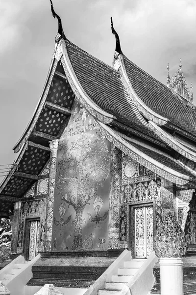 Black and white picture of Wat Xieng Thong buddhist temple of the Golden City Luang Prabang Laos.