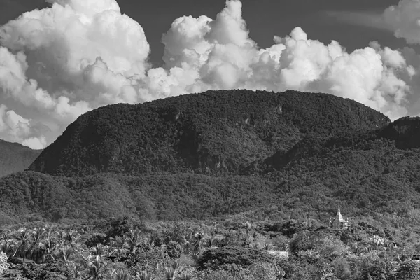 Black and white panorama of the mountain landscape and Wat Phol Phao temple in Luang Prabang Laos in Southeast Asia.