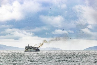 Don Sak Surat Thani Tayland yakınlarında siyah duman dumanı dumanlı eski bir gemi..
