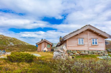 Amazing Vavatn landscape panorama view cottages and mountains with snow during summer in Hemsedal Norway.