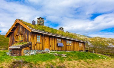 Amazing Vavatn landscape panorama view cottages and mountains with snow during summer in Hemsedal Norway.