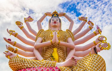 Koh Samui adası Surat Thani Tayland 'daki Wat Plai Laem tapınağındaki Tanrıça Guan Yin' in 18 kollu renkli heykeli..