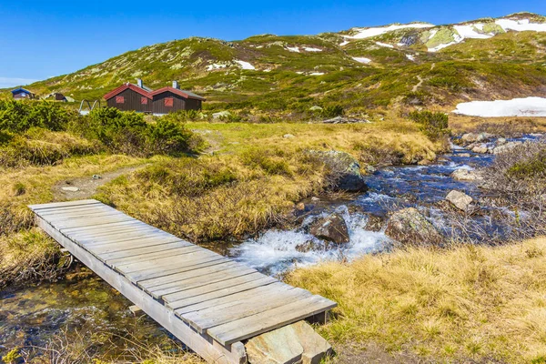 stock image Small wooden bridge and footpath over river of Vavatn lake in Hemsedal, Norway.