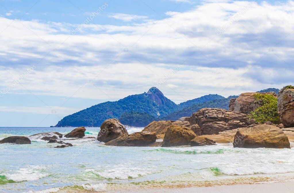 Huge rocks and waves at amazing Praia de Lopes Mendes beach on the big tropical island Ilha Grande in Angra dos Reis Rio de Janeiro Brazil.