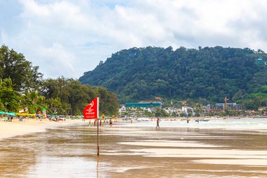 Kathu Phuket Thailand 08. October 2025 Patong Beach bay sea coast panorama view with promenade tourists people turquoise blue clear water waves and green mountains and palm trees in Patong Thailand.