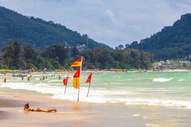 Kathu Phuket Thailand 08. October 2025 Patong Beach bay sea coast panorama view with promenade tourists people turquoise blue clear water waves and green mountains and palm trees in Patong Thailand.
