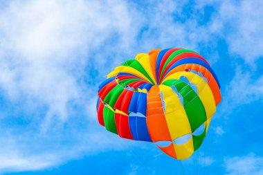 Kathu Phuket Thailand 10. October 2025 Patong Beach bay sea coast panorama view with people tourism and parasailing parachute sport activity water waves mountains and clouds in Patong Phuket Thailand.
