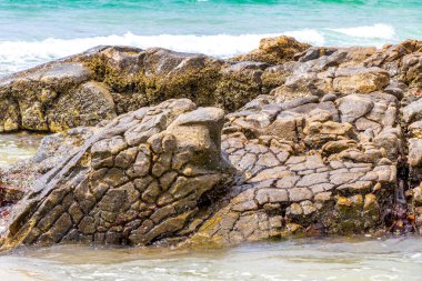 Amazing beach tropical landscape panorama view with turquoise blue water waves and rocks in Patong Beach Kathu District Phuket Island Province Southern Thailand in Southeast Asia.