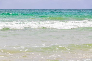 Waves turquoise blue water and sand at tropical beach and sea in Patong Beach Kathu District Phuket Island Province Southern Thailand in Southeast Asia.