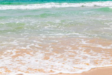 Waves turquoise blue water and sand at tropical beach and sea in Patong Beach Kathu District Phuket Island Province Southern Thailand in Southeast Asia.