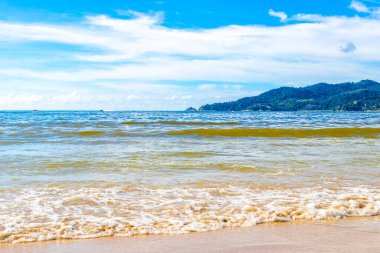 Waves turquoise blue water and sand at tropical beach and sea in Patong Beach Kathu District Phuket Island Province Southern Thailand in Southeast Asia.