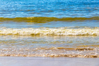 Waves turquoise blue water and sand at tropical beach and sea in Patong Beach Kathu District Phuket Island Province Southern Thailand in Southeast Asia.