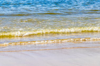 Waves turquoise blue water and sand at tropical beach and sea in Patong Beach Kathu District Phuket Island Province Southern Thailand in Southeast Asia.