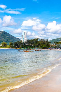 Kathu Phuket Thailand 13. October 2025 Patong Beach bay sea coast panorama view with promenade tourists people turquoise blue water boats mountains and palm trees in Patong Phuket Thailand.