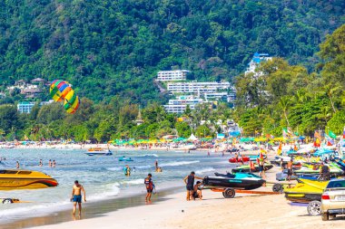 Kathu Phuket Thailand 13. October 2025 Patong Beach bay sea coast panorama view with promenade tourists people turquoise blue water boats mountains and palm trees in Patong Phuket Thailand.