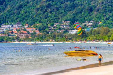 Kathu Phuket Thailand 13. October 2025 Patong Beach bay sea coast panorama view with promenade tourists people turquoise blue water boats mountains and palm trees in Patong Phuket Thailand.