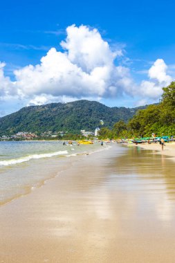 Kathu Phuket Thailand 13. October 2025 Patong Beach bay sea coast panorama view with promenade tourists people turquoise blue water boats mountains and palm trees in Patong Phuket Thailand.