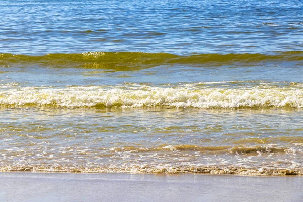 Waves turquoise blue water and sand at tropical beach and sea in Patong Beach Kathu District Phuket Island Province Southern Thailand in Southeast Asia.