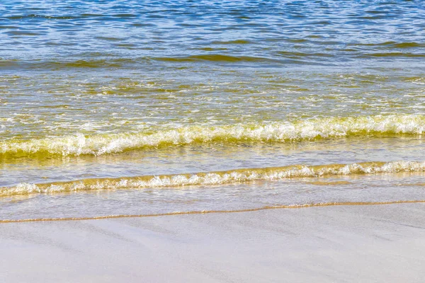 Waves turquoise blue water and sand at tropical beach and sea in Patong Beach Kathu District Phuket Island Province Southern Thailand in Southeast Asia.