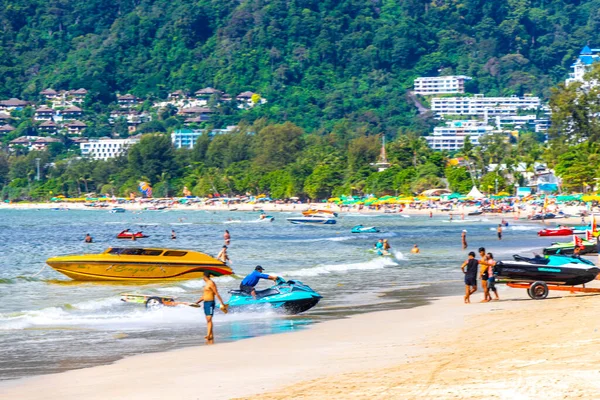 Kathu Phuket Thailand 13. October 2025 Patong Beach bay sea coast panorama view with promenade tourists people turquoise blue water boats mountains and palm trees in Patong Phuket Thailand.