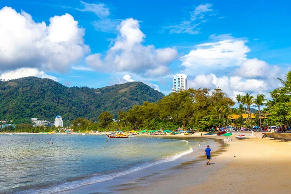 Kathu Phuket Thailand 13. October 2025 Patong Beach bay sea coast panorama view with promenade tourists people turquoise blue water boats mountains and palm trees in Patong Phuket Thailand.