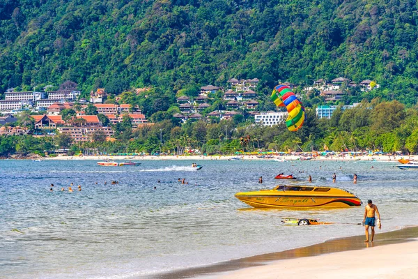 Kathu Phuket Thailand 13. October 2025 Patong Beach bay sea coast panorama view with promenade tourists people turquoise blue water boats mountains and palm trees in Patong Phuket Thailand.