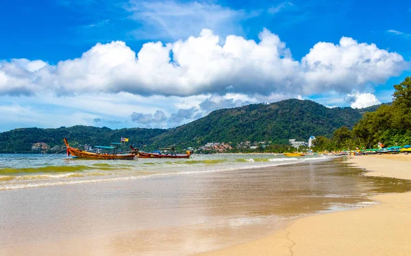Kathu Phuket Thailand 13. October 2025 Patong Beach bay sea coast panorama view with promenade tourists people turquoise blue water boats mountains and palm trees in Patong Phuket Thailand.