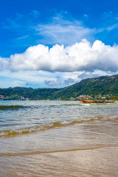 Kathu Phuket Thailand 13. October 2025 Patong Beach bay sea coast panorama view with promenade tourists people turquoise blue water boats mountains and palm trees in Patong Phuket Thailand.