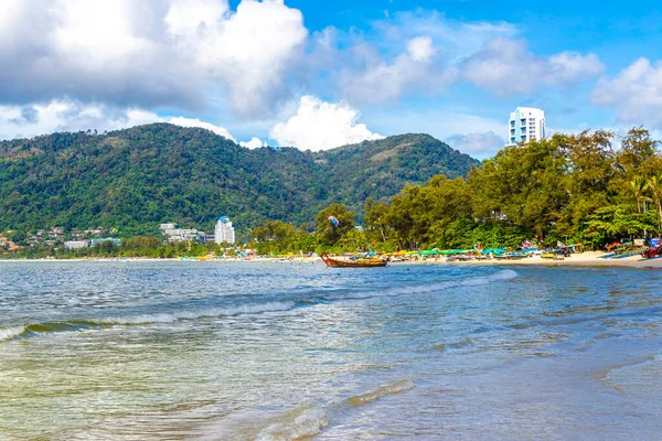 Kathu Phuket Thailand 13. October 2025 Patong Beach bay sea coast panorama view with promenade tourists people turquoise blue water boats mountains and palm trees in Patong Phuket Thailand.