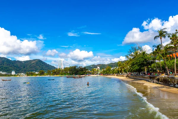 Kathu Phuket Thailand 13. October 2025 Patong Beach bay sea coast panorama view with promenade tourists people turquoise blue water boats mountains and palm trees in Patong Phuket Thailand.