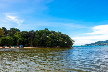 Kathu Phuket Thailand 13. October 2025 Patong Beach bay sea coast panorama view with promenade tourists people turquoise blue water boats mountains and palm trees in Patong Phuket Thailand.