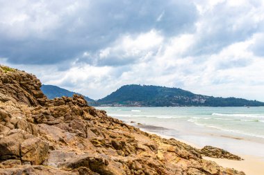 Amazing beach tropical landscape panorama view with turquoise blue water waves and rocks in Patong Beach Kathu District Phuket Island Province Southern Thailand in Southeast Asia.
