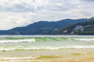 Waves turquoise blue water and sand at tropical beach and sea in Patong Beach Kathu District Phuket Island Province Southern Thailand in Southeast Asia.