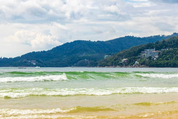 Waves turquoise blue water and sand at tropical beach and sea in Patong Beach Kathu District Phuket Island Province Southern Thailand in Southeast Asia.