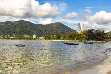 Kathu Phuket Thailand 13. October 2025 Patong Beach bay sea coast panorama view with promenade tourists people turquoise blue water boats mountains and palm trees in Patong Phuket Thailand.