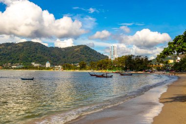 Kathu Phuket Thailand 13. October 2025 Patong Beach bay sea coast panorama view with promenade tourists people turquoise blue water boats mountains and palm trees in Patong Phuket Thailand.
