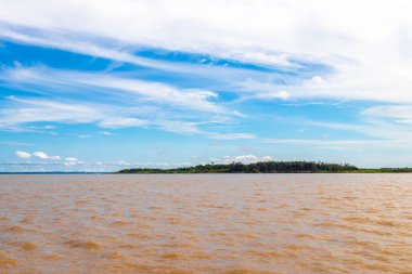 Rio Negro 'nun karasu suyu Amazon Nehri' nin beyaz suyu ve tropikal orman yağmur ormanı ve Iranduba Manaus Manaus Brezilya 'da mavi bulutlu gökyüzü ile tekne turu..