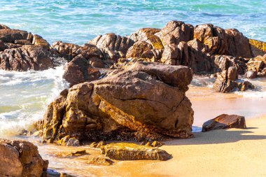 Rocky Kalim Plajı tropikal manzara manzarası turkuvaz mavisi temiz su dalgaları ile Patong Sahili 'nde Kathu Bölgesi Phuket Adası Güney Tayland' da kum ve kayalar.